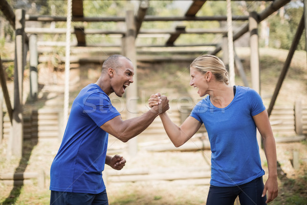 Fit man and woman greeting each other during obstacle course Stock photo © wavebreak_media