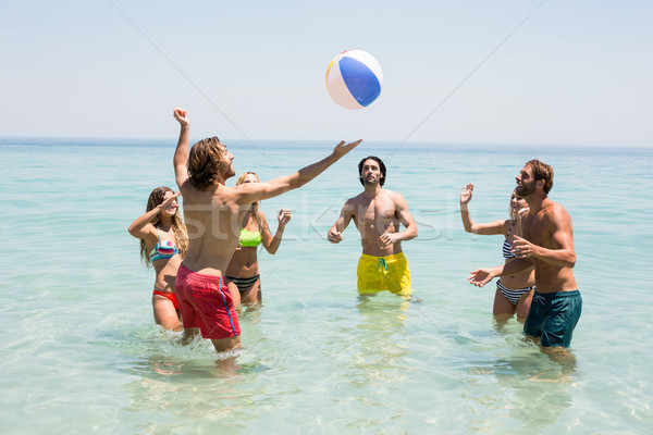 Amis jouer balle mer ciel eau [[stock_photo]] © wavebreak_media