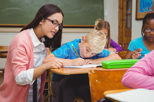 Smiling teacher helping a student Stock photo © wavebreak_media