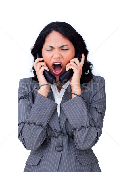 Angry businesswoman tangled up in phone wires Stock photo © wavebreak_media