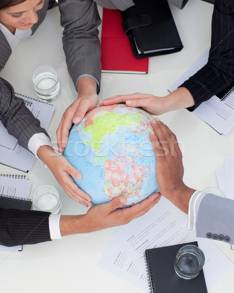 Close-up of multi-ethnic business people holding a terrestrial g Stock photo © wavebreak_media