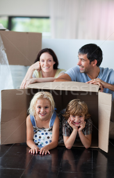 Happy family playing at home with boxes Stock photo © wavebreak_media
