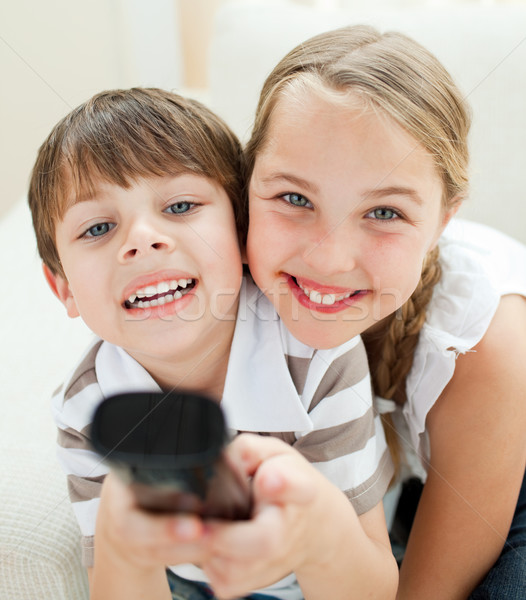 Cute brother and sister watching TV Stock photo © wavebreak_media