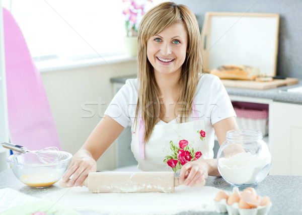 Delighted woman is preparing a cake in the kitchen Stock photo © wavebreak_media