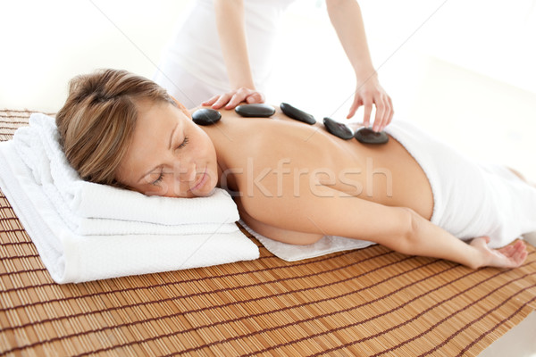 Stock photo: Delighted woman lying on a massage table