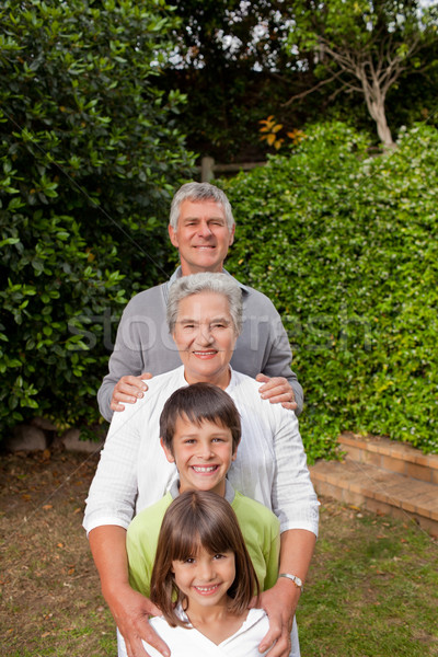 Nagyszülők unokák néz kamera család boldog Stock fotó © wavebreak_media