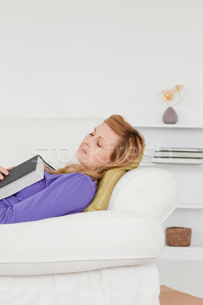 Attractive woman lying on the sofa who has fallen asleep while reading a book  Stock photo © wavebreak_media