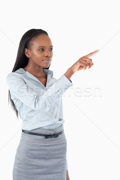 Portrait of a young businesswoman pressing an invisible key against a white background Stock photo © wavebreak_media
