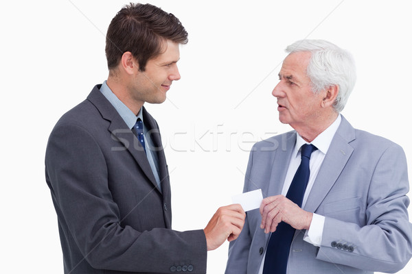 Close up of businessman giving business card to trades partner against a white background Stock photo © wavebreak_media