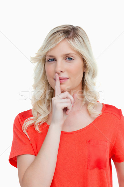 Attractive young woman looking at the camera while telling to shut up Stock photo © wavebreak_media
