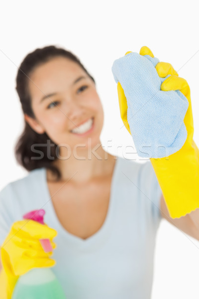 Happy woman cleaning a window on a white background Stock photo © wavebreak_media