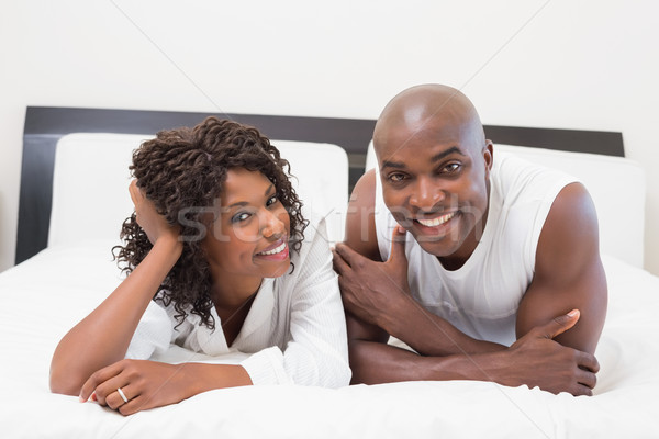 Heureux couple lit ensemble maison chambre [[stock_photo]] © wavebreak_media