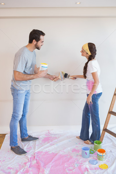 Cute couple painting the wall Stock photo © wavebreak_media