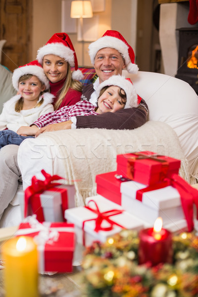 Festive family in santa hat hugging on couch Stock photo © wavebreak_media