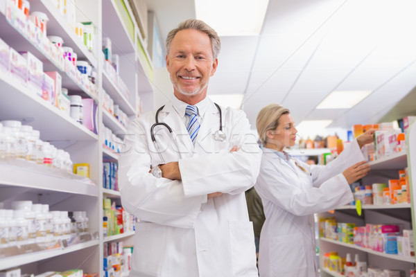Pharmacist with arms crossed and trainee behind Stock photo © wavebreak_media