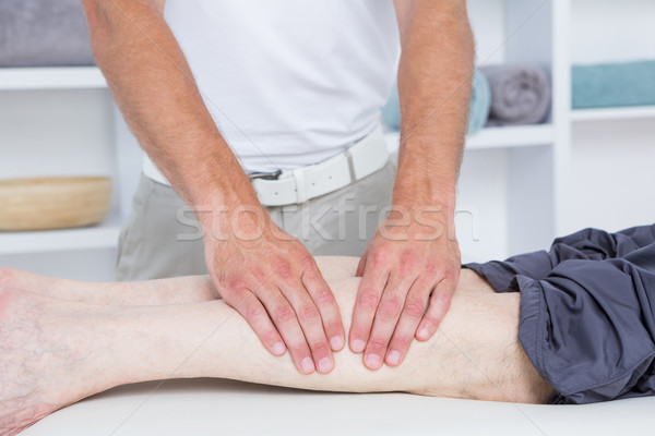 Physiotherapist doing leg massage to his patient  Stock photo © wavebreak_media