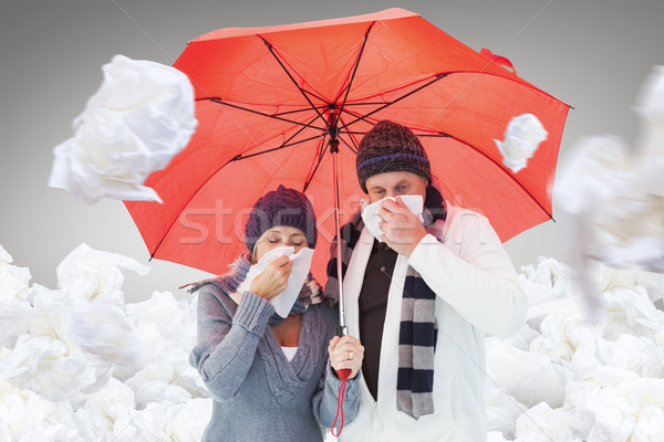 Composite image of mature couple blowing their noses under umbre Stock photo © wavebreak_media