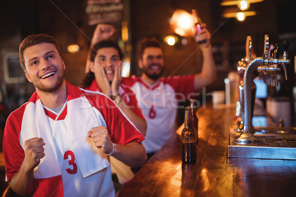 Group of male friends watching football match Stock photo © wavebreak_media