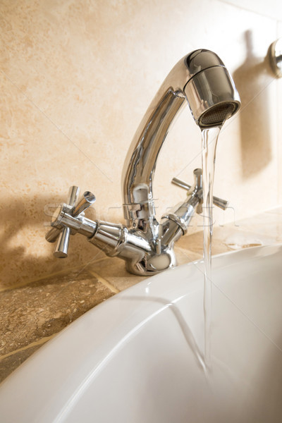 Közelkép víz folyik vízcsap fürdőszoba fal Stock fotó © wavebreak_media