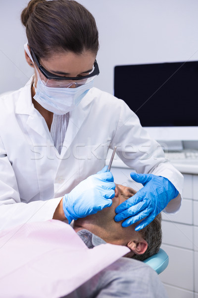 Man receiving dental treatment by dentist Stock photo © wavebreak_media