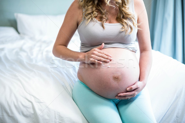 Pregnant woman applying cream on her belly Stock photo © wavebreak_media