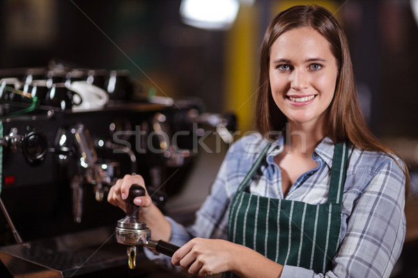 Smiling barista preparing coffee with machine Stock photo © wavebreak_media
