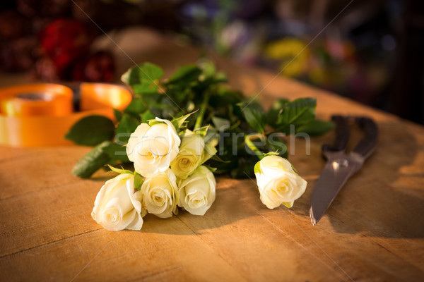 Bunch of roses with shears and poly ribbon on the wooden table Stock photo © wavebreak_media