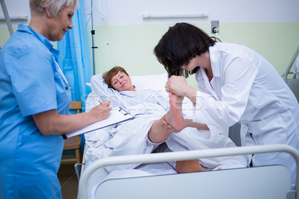 Doctor giving foot treatment to patient Stock photo © wavebreak_media