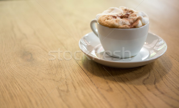 Coffee cup with creamy froth on table at cafe Stock photo © wavebreak_media