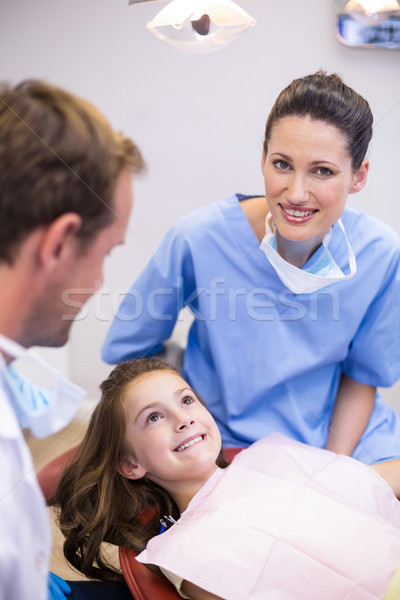Smiling dentists interacting with young patient Stock photo © wavebreak_media