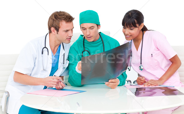 Stock photo: Concentrated medical team looking at X-ray