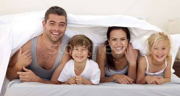 Parents and children playing in parent's bed Stock photo © wavebreak_media