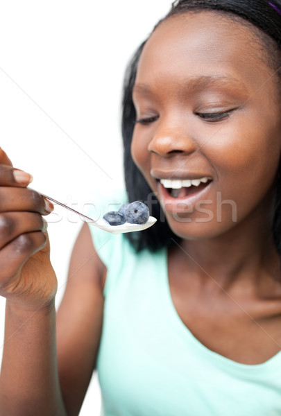 Afro-american woman eating a yogurt with blueberries  Stock photo © wavebreak_media
