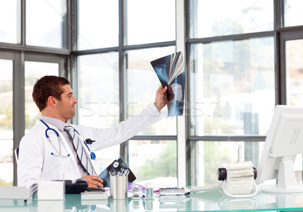 Beautiful doctor analyzing an x-ray in his office Stock photo © wavebreak_media
