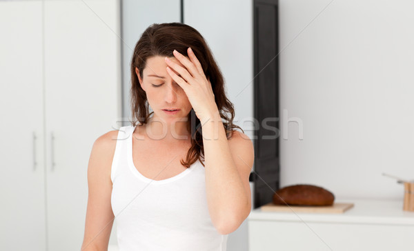 Exhausted woman having a headache in her bathroom at home Stock photo © wavebreak_media