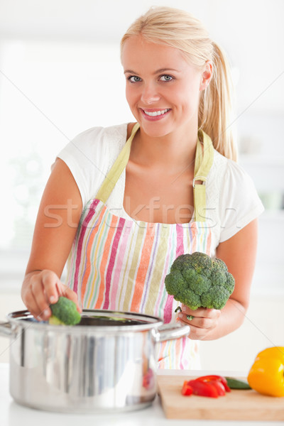 Portrait of a smiling woman putting cabbage on water while looking at the camera Stock photo © wavebreak_media