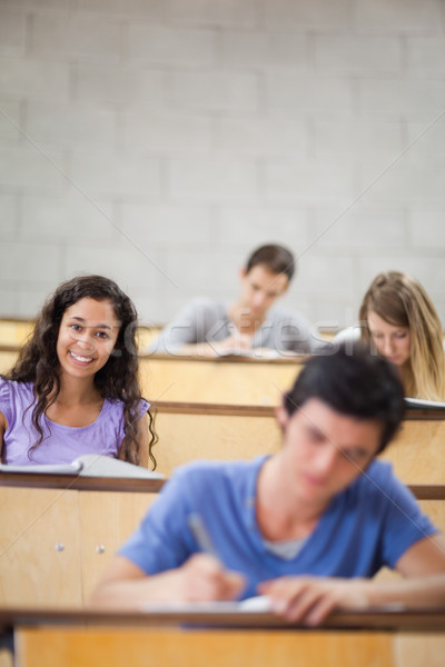 Portrait of students during a lecture with the camera focus on a model Stock photo © wavebreak_media