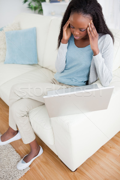 Stock photo: Notebook causes headache to young woman