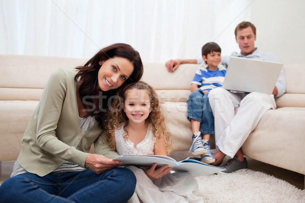 Stock photo: Family spending leisure time in the living room together