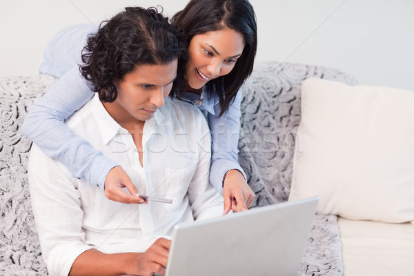 Stock photo: Young couple booking vacations online