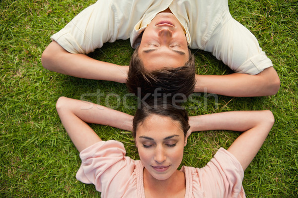 Close-up of a man and a woman with their eyes closed lying head to head with both of their arms rest Stock photo © wavebreak_media