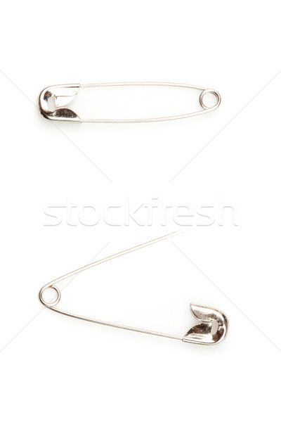 Two safety pin one opening an the other closing against a white background Stock photo © wavebreak_media