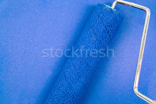 Bluebackground with a paint roller in the middle Stock photo © wavebreak_media