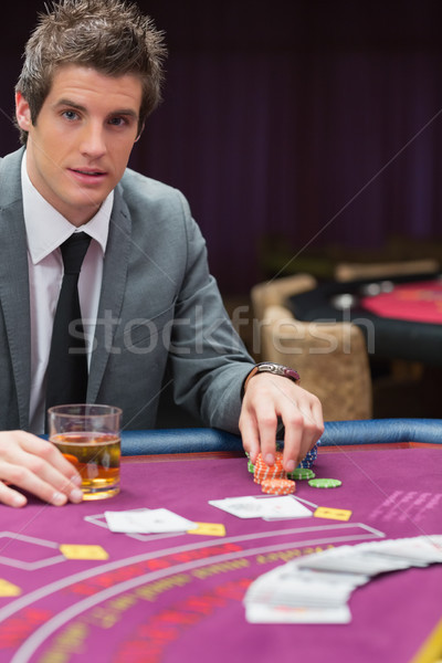 Man sitting at poker table with whiskey in casino Stock photo © wavebreak_media