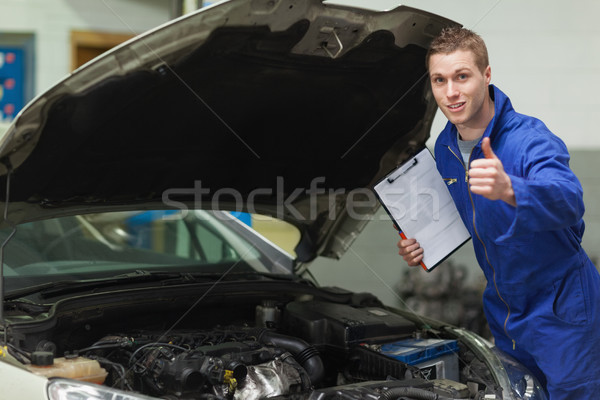 Mechanic with clipboard gesturing thumbs up Stock photo © wavebreak_media