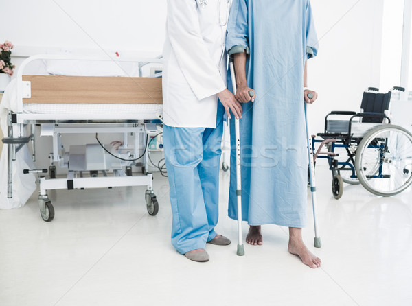 Doctor helping patient in crutches at the hospital Stock photo © wavebreak_media