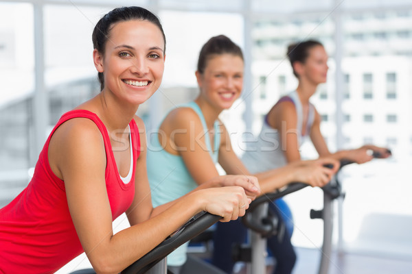 Stock photo: Fit young people working out at spinning class