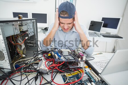 Stressed computer engineer working on broken cables Stock photo © wavebreak_media