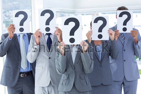 Business people holding question mark signs in office Stock photo © wavebreak_media