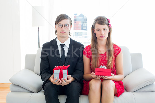 Unsmiling geeky couple with gift Stock photo © wavebreak_media